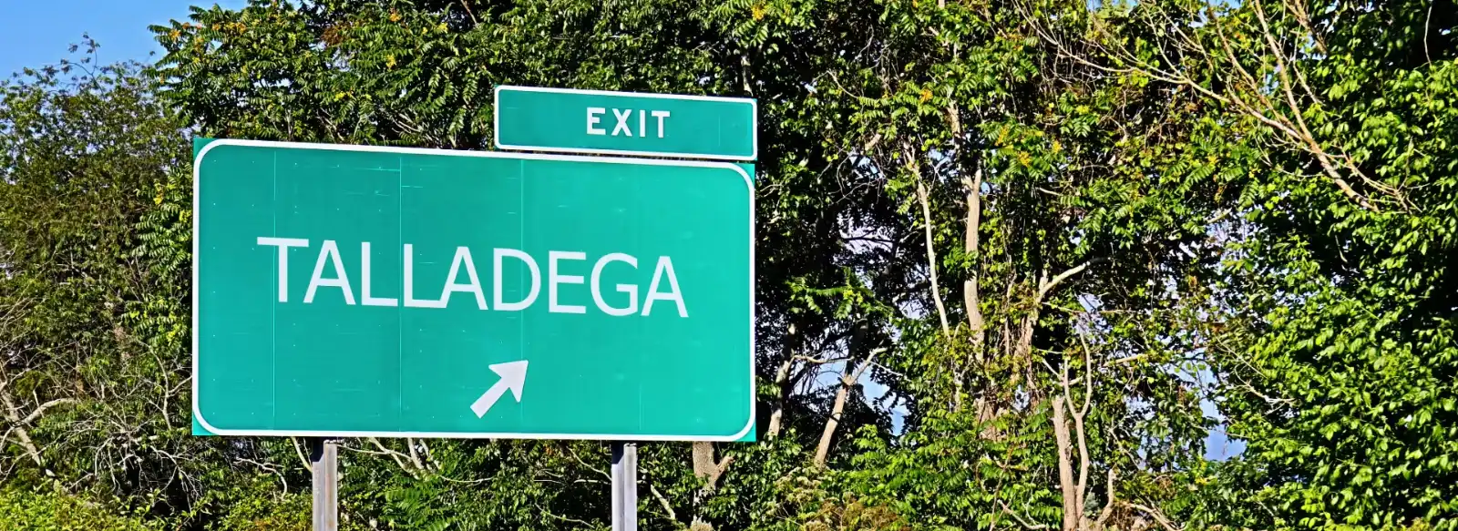 Highway exit sign for Talladega, Alabama, where Sweepers provides commercial cleaning